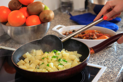 Pan frying potatoes with parsley