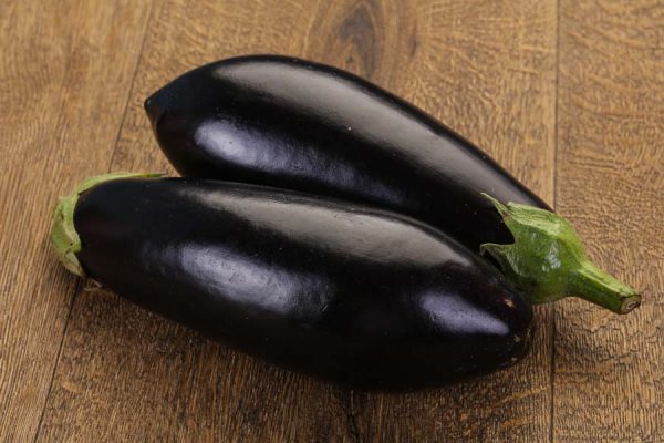 Two eggplants on a board