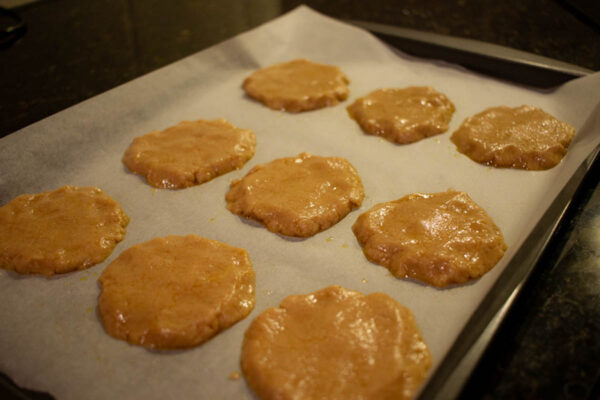 A tray of gingernut biscuits starting to bake