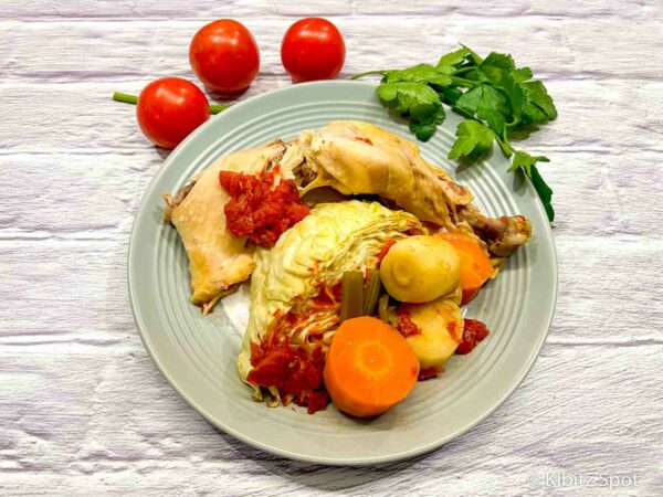 Chicken and cabbage with tomato from a crockpot on a plate ready to eat