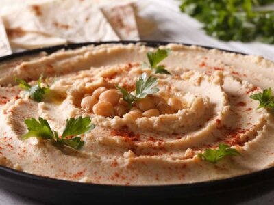 Naturally gluten-free hummus with paprika and parsley on the plate