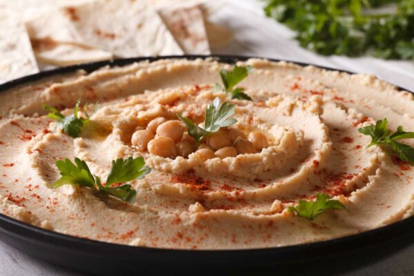 Naturally gluten-free hummus with paprika and parsley on the plate