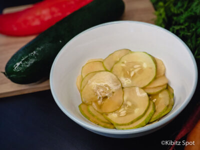 A bowl of homemade deli-style pickled cucumber salad ready to eat.