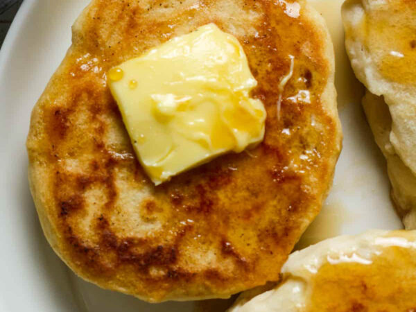 close up of a pancake with a pad of vegan butter