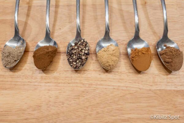 The six spices needed for our chai spice mix along with a cinnamon stick.