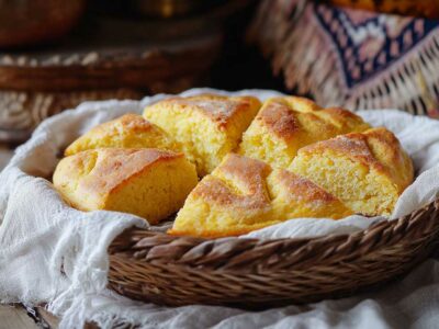 Albanian cornbread with feta cheese in a basket ready to serve.