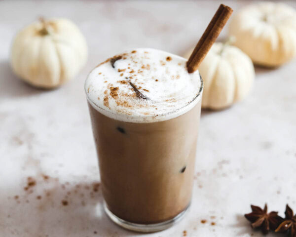 Iced pumpkin spice latte with a foamy top