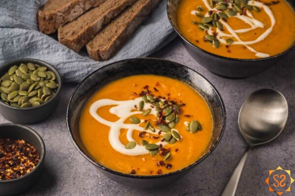 A bowl of carrot and pumpkin soup