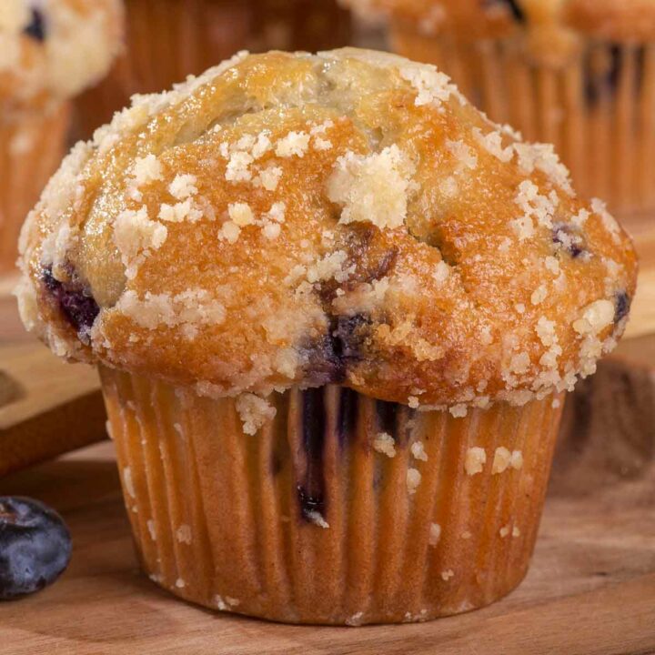 A gluten-free blueberry muffin topped with a bit of streusel