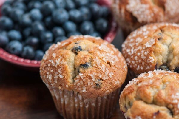 Gluten-free blueberry muffins topped with sugar crystals