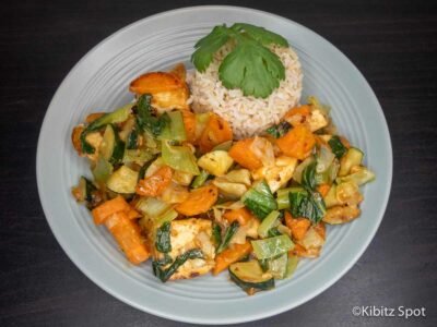 Vegan stir fry tofu with peanut satay sauce served on a plate with rice